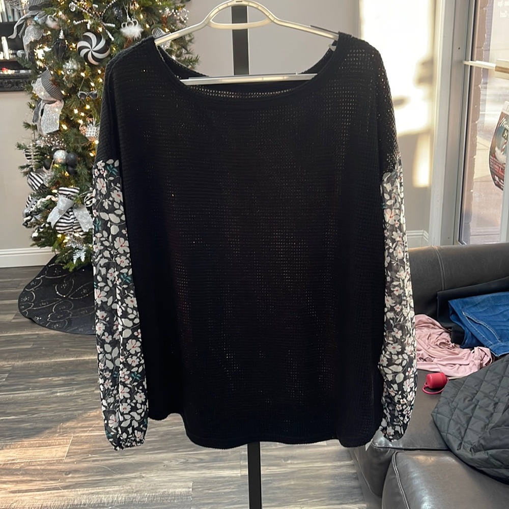 Black long sleeve sweater with flowers on the sleeves. Brand new!
